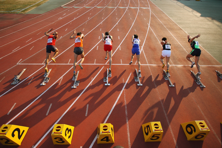 Track Athletes Sprinting at the Start Line